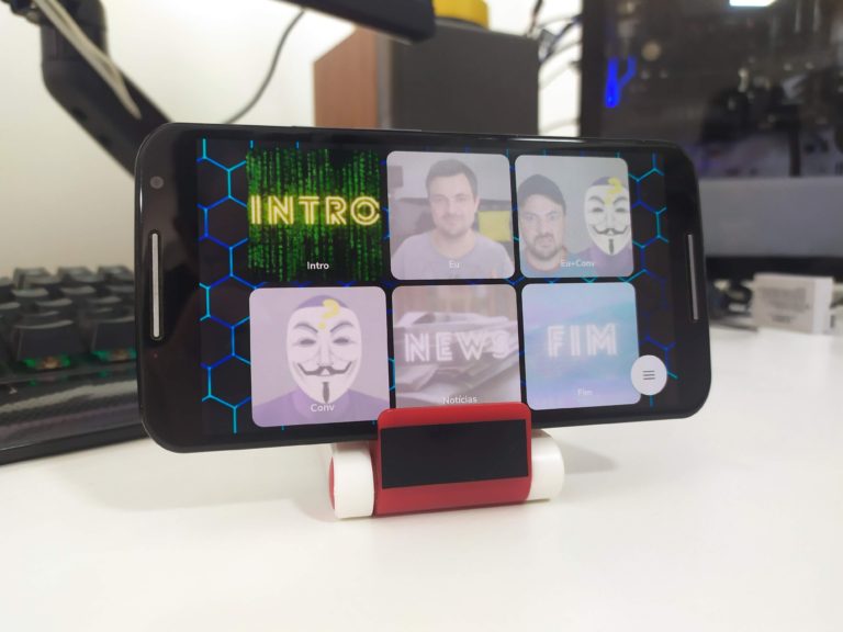 Smartphone posicionado em um suporte de mesa sendo utilizado como um Stream Deck caseiro com atalhos para lives.