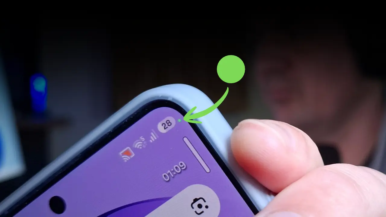 Detalhe da tela de um smartphone Android mostrando a bolinha verde de privacidade acesa no canto superior direito.